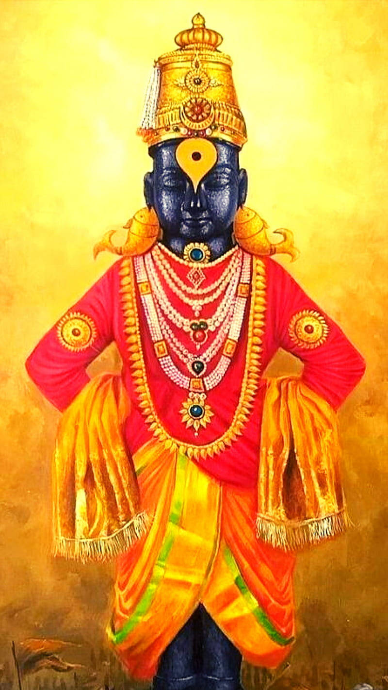 Indian 桌布 壁紙 — 一位神聖的藍皮膚神祇，裝飾著鮮豔的紅色和金色服飾，佩戴精緻珠寶，站在燦爛的金色背景前。