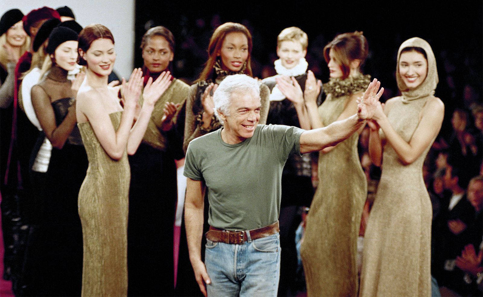 ralph lauren 桌布 壁紙 — 一位穿著休閒服裝的快樂設計師向穿著優雅金色連衣裙的模特兒們的掌聲揮手。