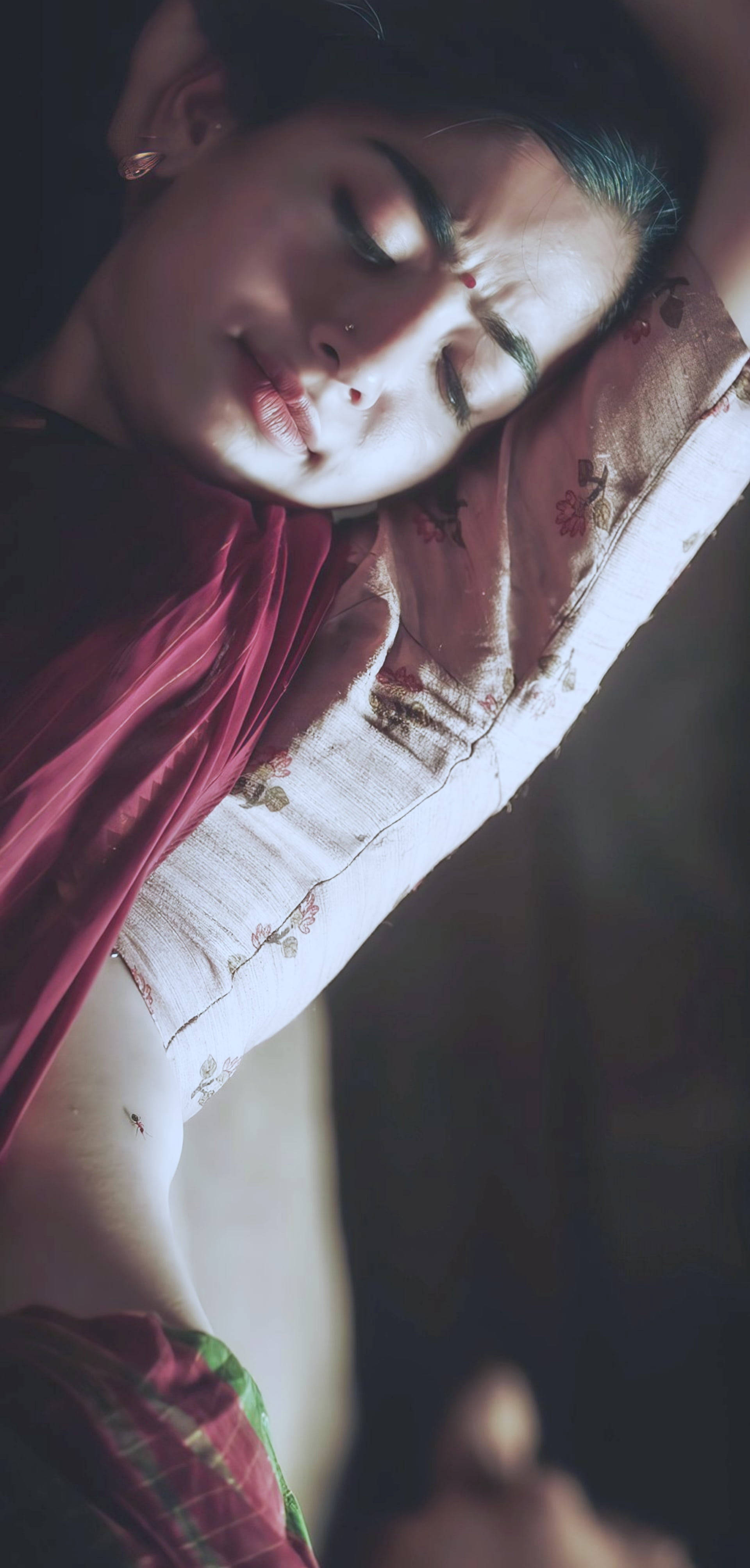 Sleeping 桌布 壁紙 — 一位穿著傳統服飾的女性在黑暗背景下，閉上眼睛沐浴在柔和的金色光芒中，平靜地休息。