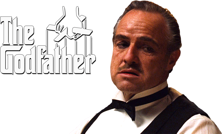 教父 桌布 壁紙 — 一位穿著燕尾服的嚴肅男子在黑色背景前凝視，旁邊是帶有木偶手的《教父》標誌。