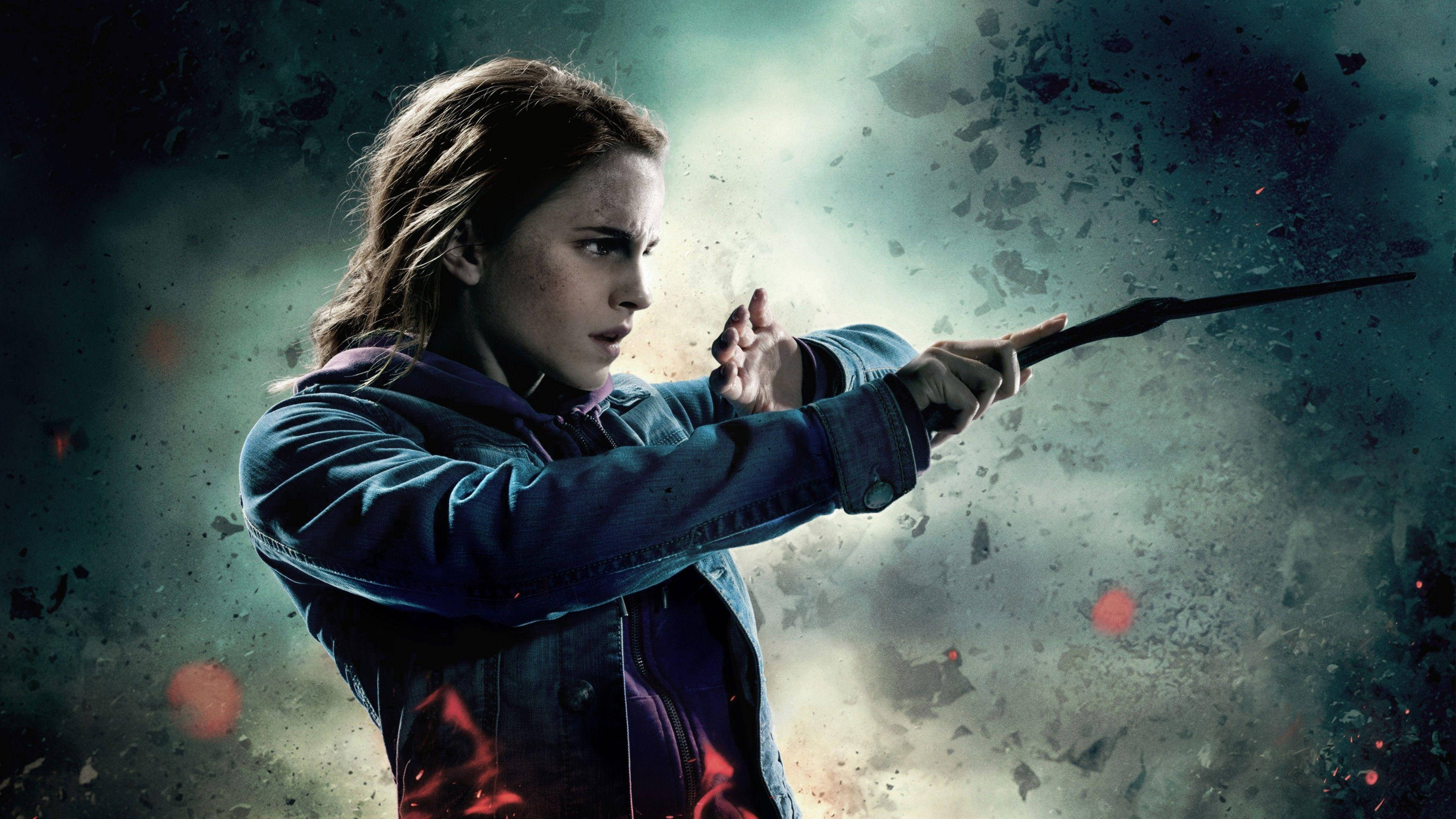 Hermione 桌布 壁紙 — 一位穿著牛仔外套的堅定年輕女子，在風暴背景下，於飛揚的碎片和熾熱的火花中揮舞魔杖。