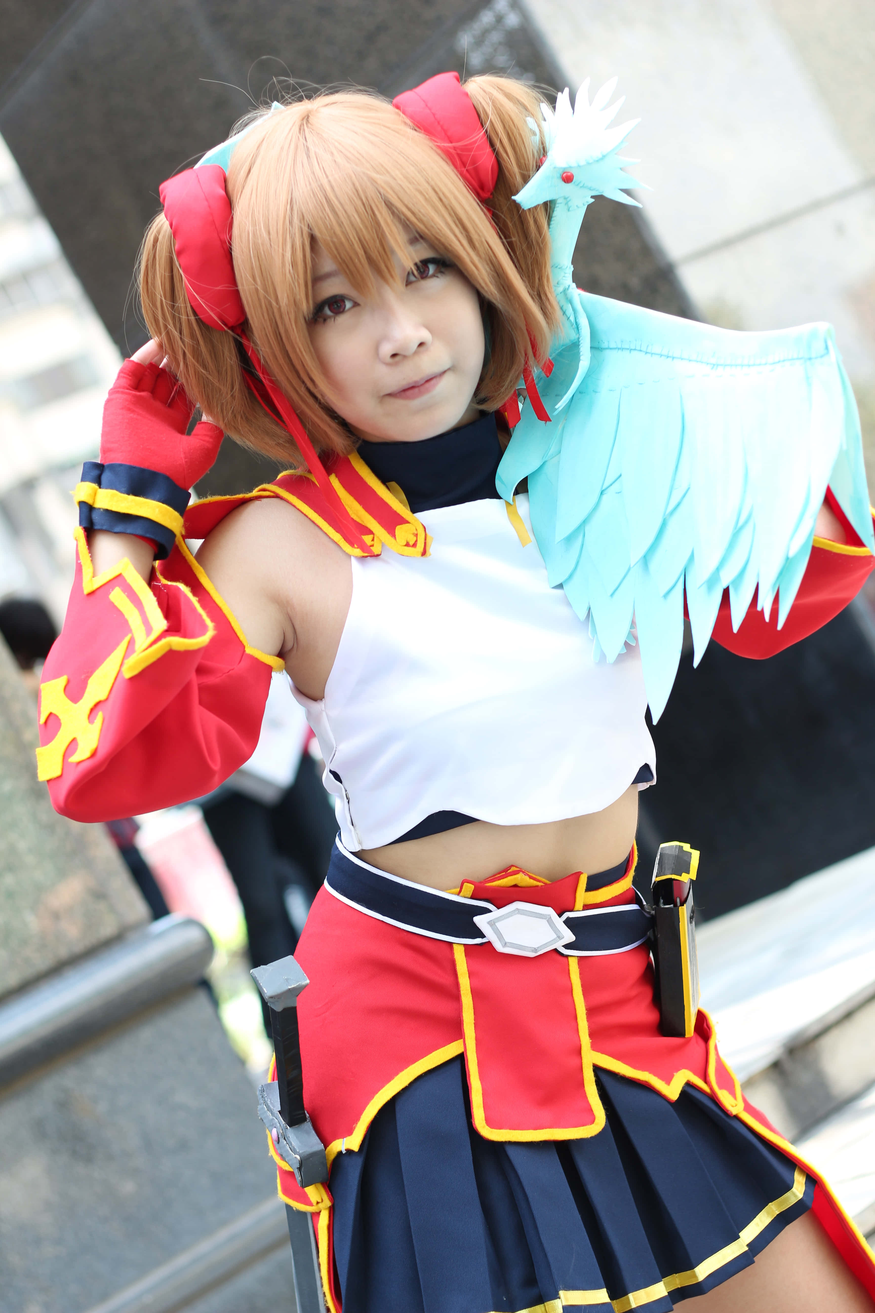 Sword Art Online Cosplay 桌布 壁紙 — 一位穿著鮮豔紅藍色動漫服裝的cosplayer，肩上棲著一隻藍色小鳥，自信地在戶外擺姿勢。