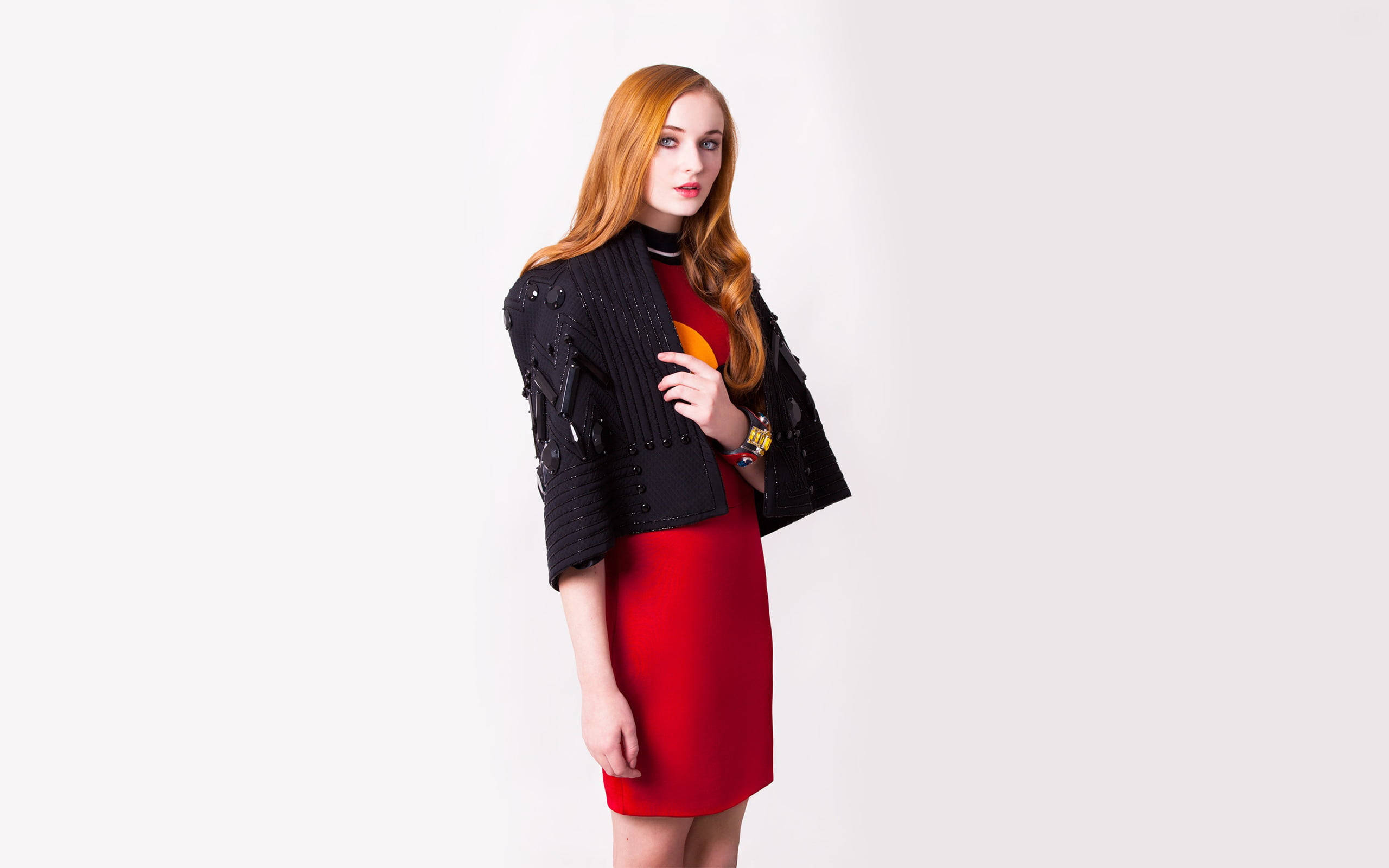 Sophie 桌布 壁紙 — 一位紅髮女性穿著紅色連衣裙和黑色珠飾外套，背景為純白色。