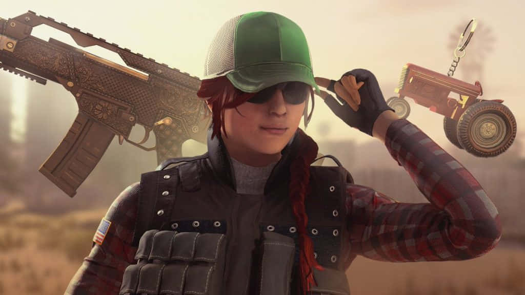 Rainbow Six Siege Ash 桌布 壁紙 — 一位紅髮女玩家戴著綠色帽子、穿著格紋襯衫，在塵土飛揚的田野中手持玩具拖拉機，肩上扛著一把裝飾步槍。
