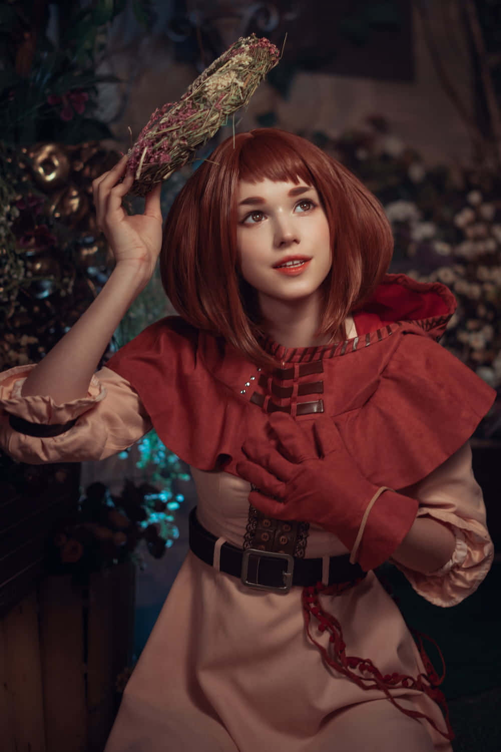 Gaming Cosplay 桌布 壁紙 — 一位紅髮年輕女性穿著復古紅色和米色服裝，在深色花卉背景前手持乾燥花環。
