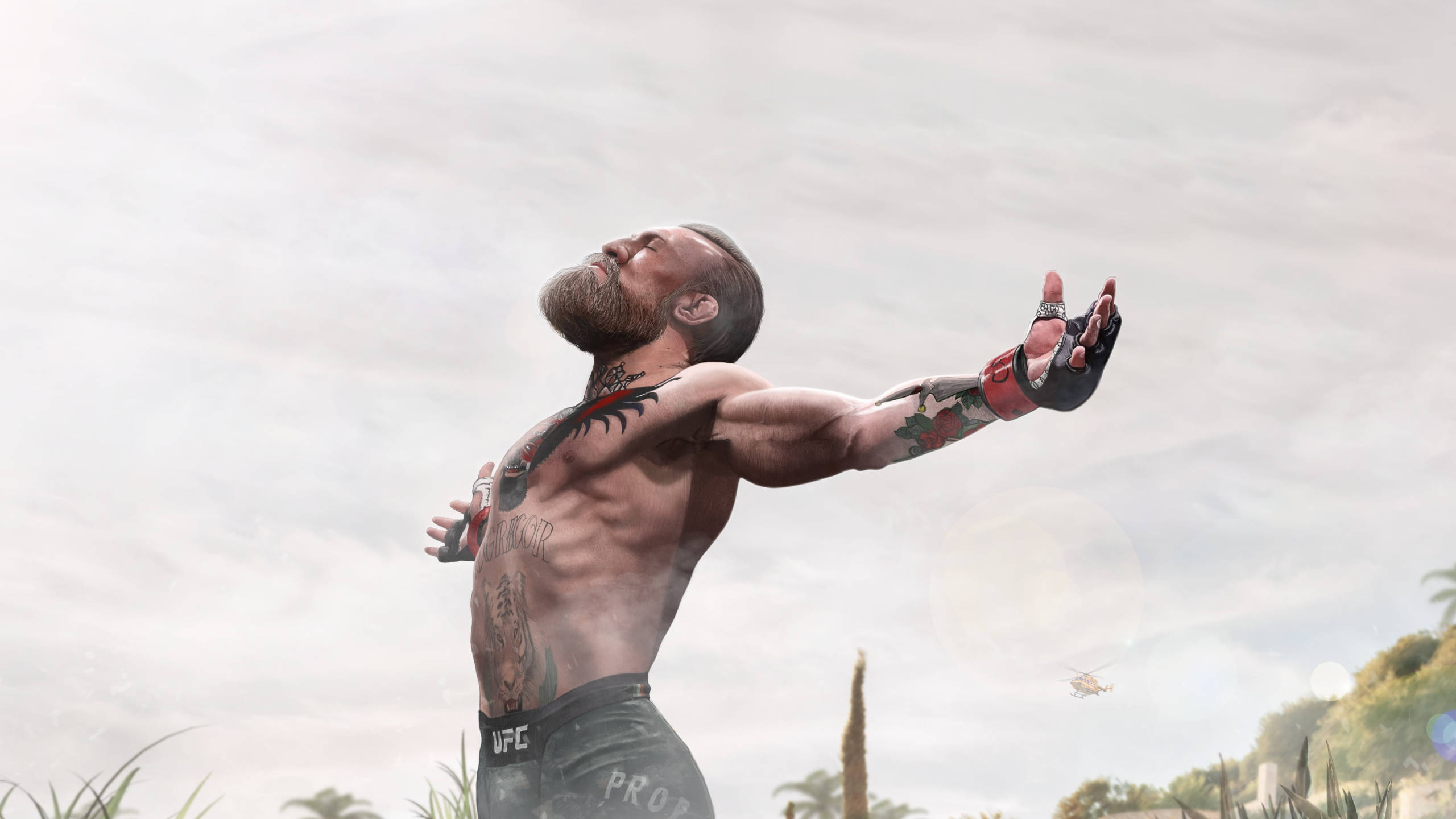 Mcgregor 桌布 壁紙 — 一位紋身的UFC短褲鬥士在陰天和遠處有直升機的情況下張開雙臂站立。