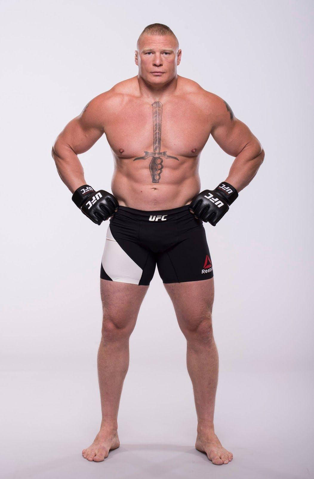 UFC 桌布 壁紙 — 一位肌肉發達、帶有劍紋身的戰士，自信地穿著UFC裝備站在純白色背景前。