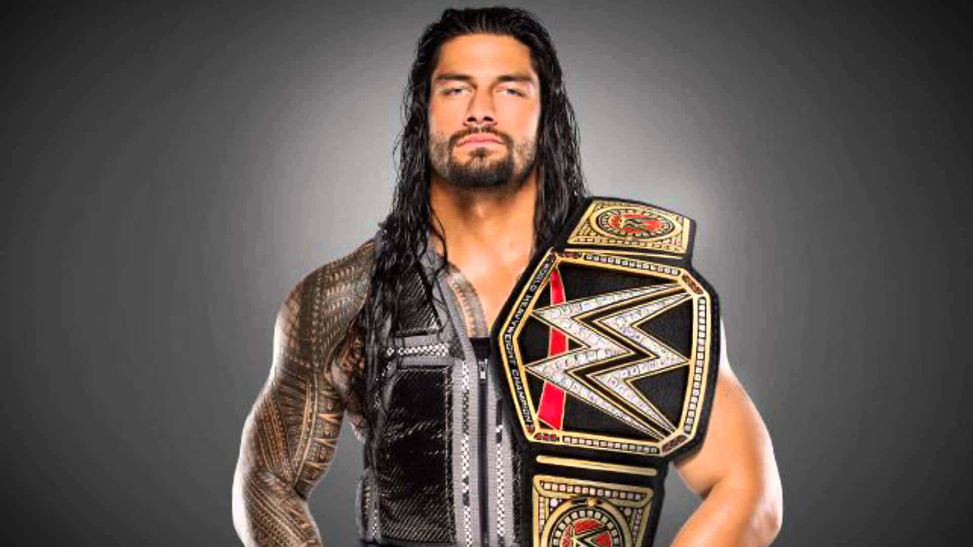 WWE Logo 桌布 壁紙 — 一位肌肉發達的摔角手，留著深色長髮和刺青，在深色漸變背景上佩戴閃亮的冠軍腰帶。