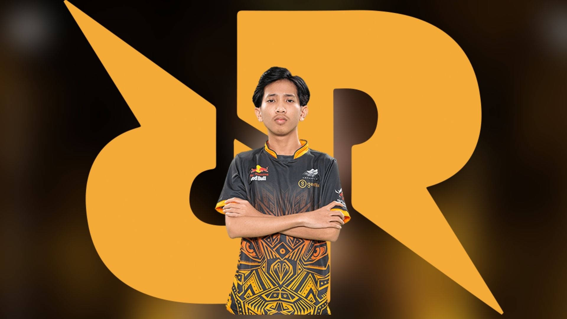 Team 桌布 壁紙 — 一位自信的電競運動員穿著圖案球衣，交叉雙臂站在一個大型風格化橙色 'R' 標誌前面。