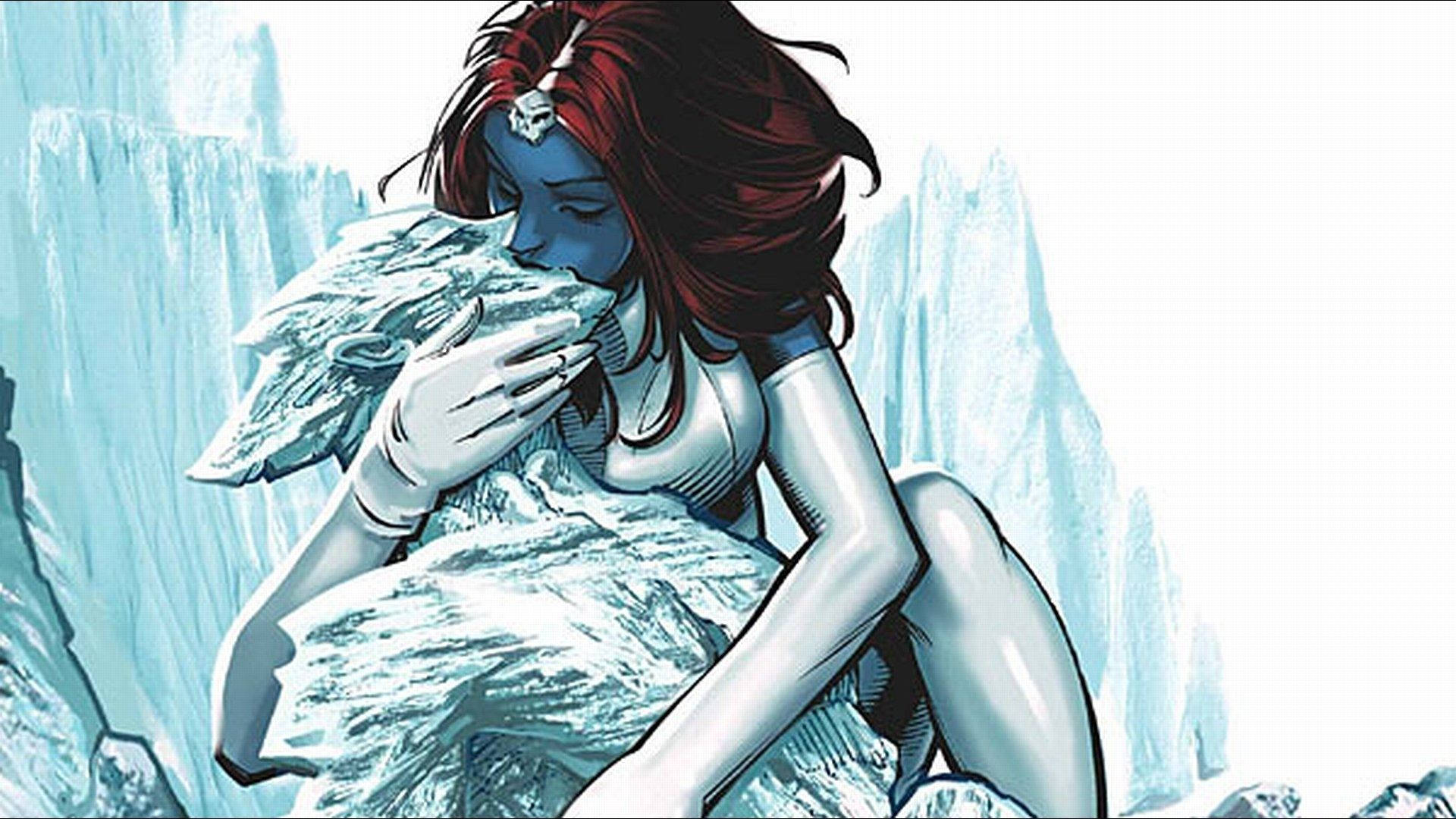 魔形女 桌布 壁紙 — 一位藍皮膚紅髮的女性在冰天雪地的山區地形中懷抱著一隻雪豹幼崽。