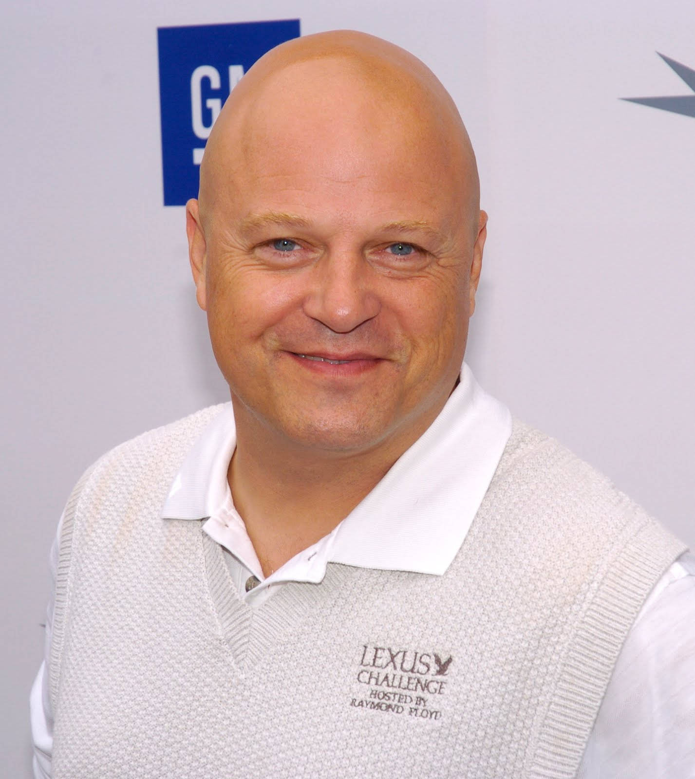 actor 桌布 壁紙 — 一位藍眼睛的光頭男子穿著白色Polo衫和淺灰色背心，在Lexus Challenge活動中溫暖地微笑。