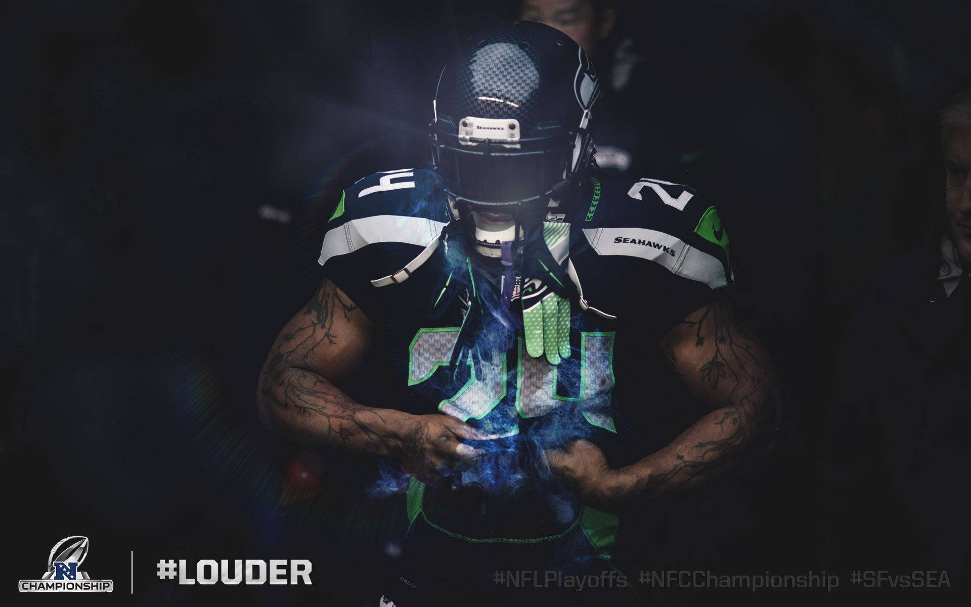 Seattle Seahawks 桌布 壁紙 — 一位西雅圖海鷹隊美式足球員在昏暗的球場燈光下，雙手捧著一個發藍光的物體，煙霧從手中升起。