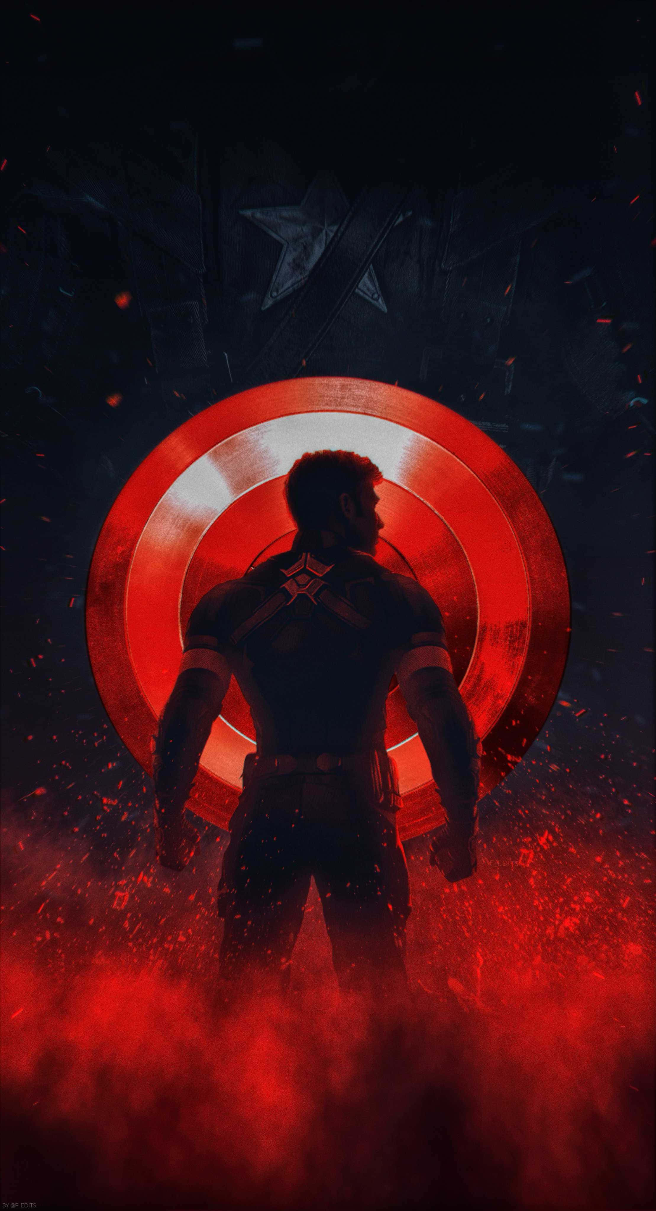 Captain America Cool 桌布 壁紙 — 一位超級英雄在黑暗的戰場上，以熾熱的餘燼為背景，在發光的紅色盾牌襯托下呈現剪影。