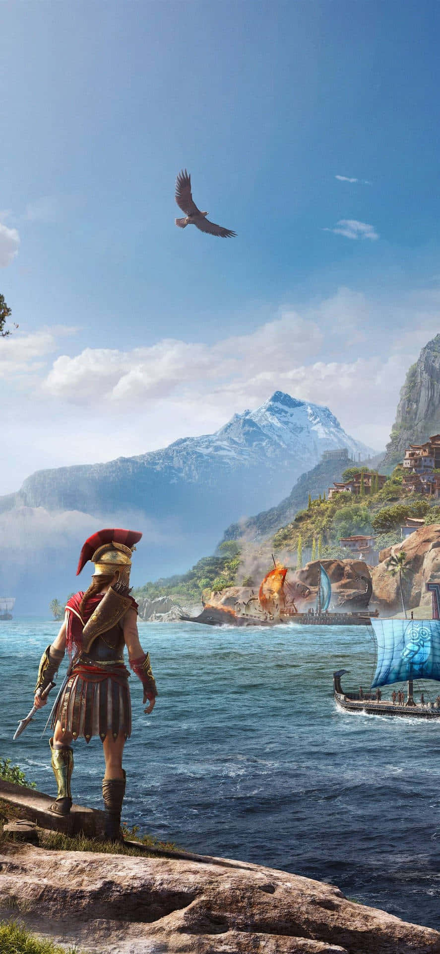 iPhone X Assassin's Creed Valhalla 桌布 壁紙 — 一位身穿古代盔甲的戰士站在懸崖上，俯瞰著一個沿海村莊，村莊有雪山和帆船，天空清澈湛藍。