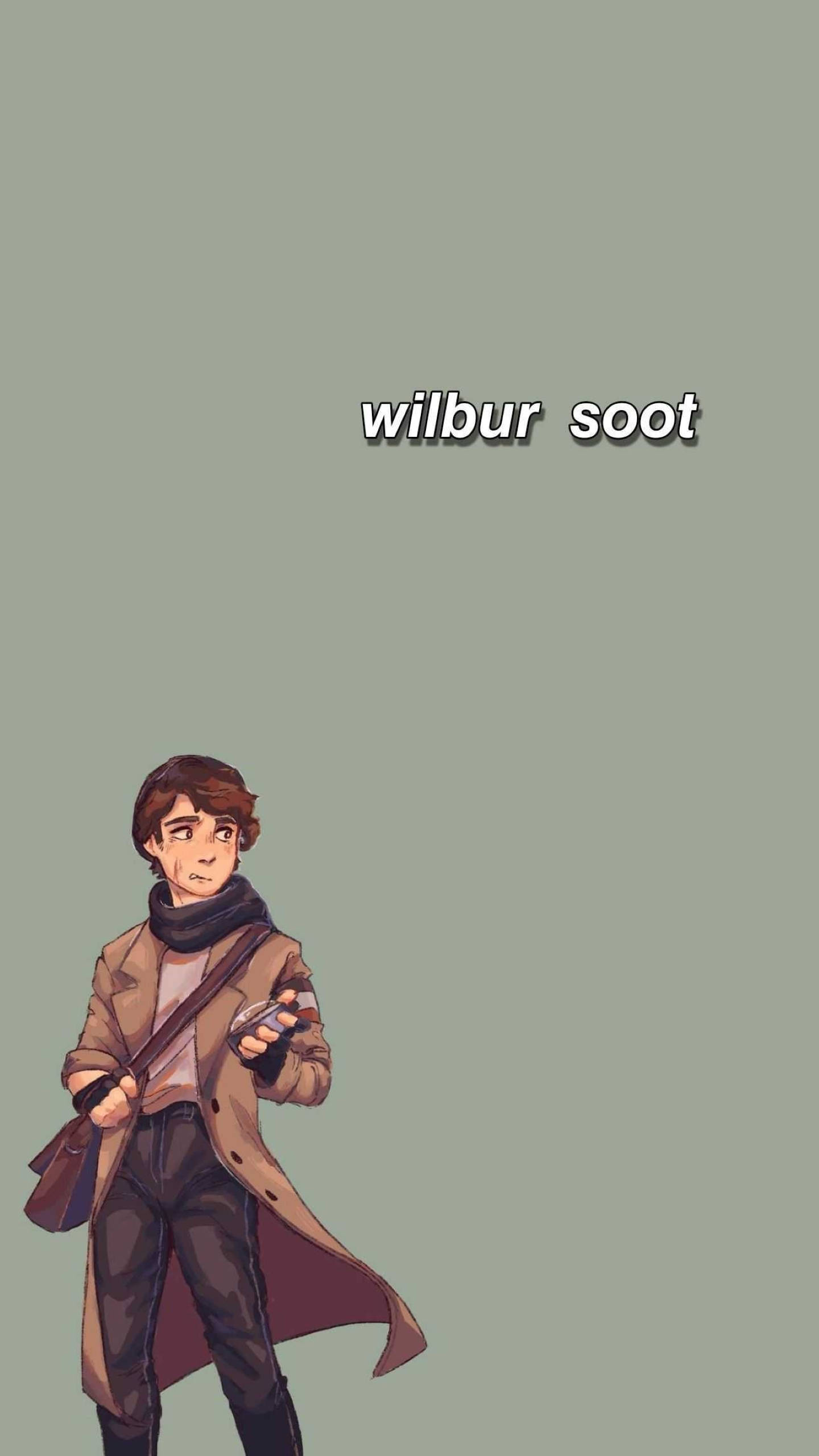 Wilbur 桌布 壁紙 — 一位身穿棕色外套和圍巾的年輕男子，在柔和的綠色背景前手持裝置，上方寫有他的名字。