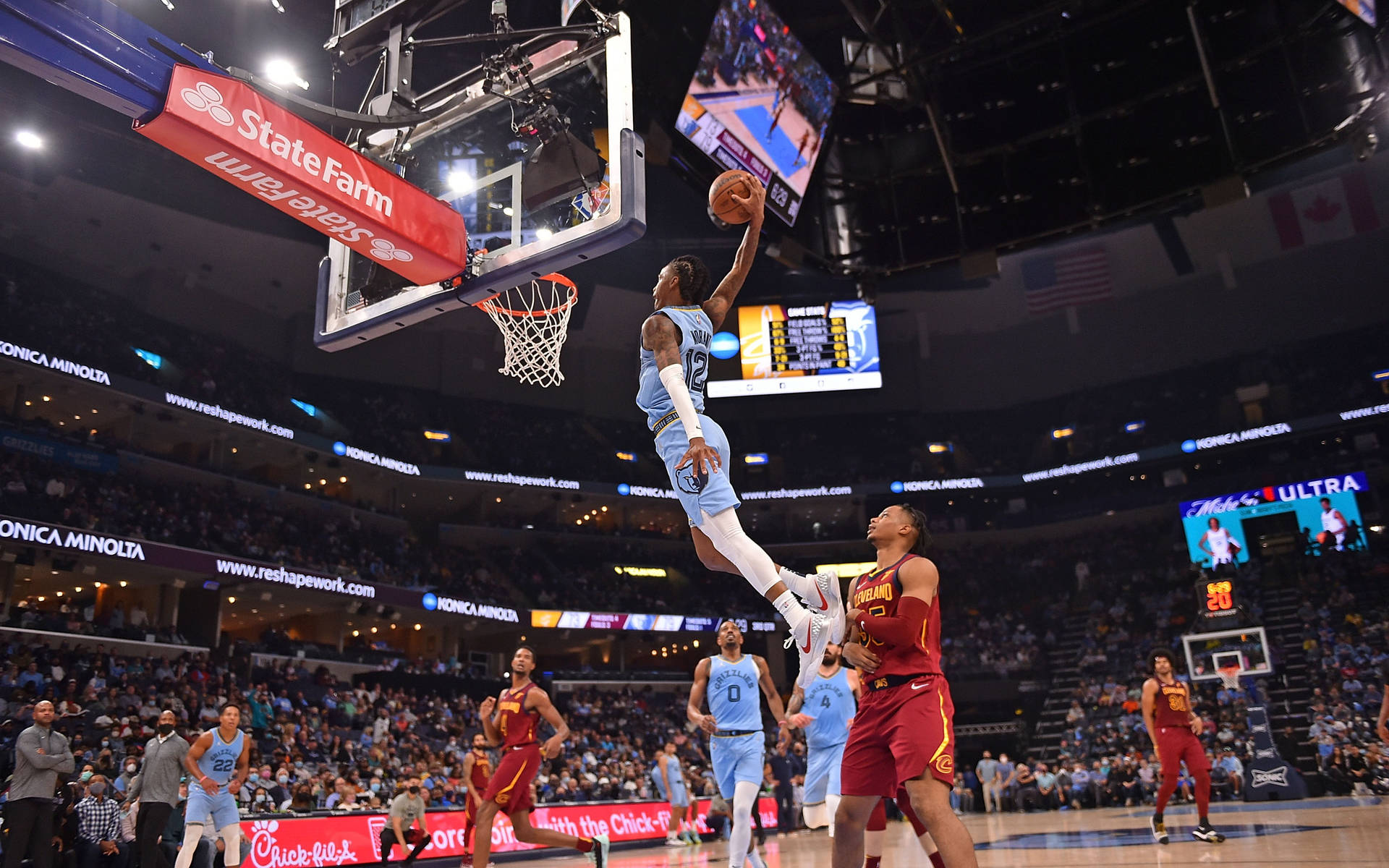 職業籃球運動員在比賽中，背景有觀眾，執行一次灌籃。 — Ja Morant 動圖 壁紙