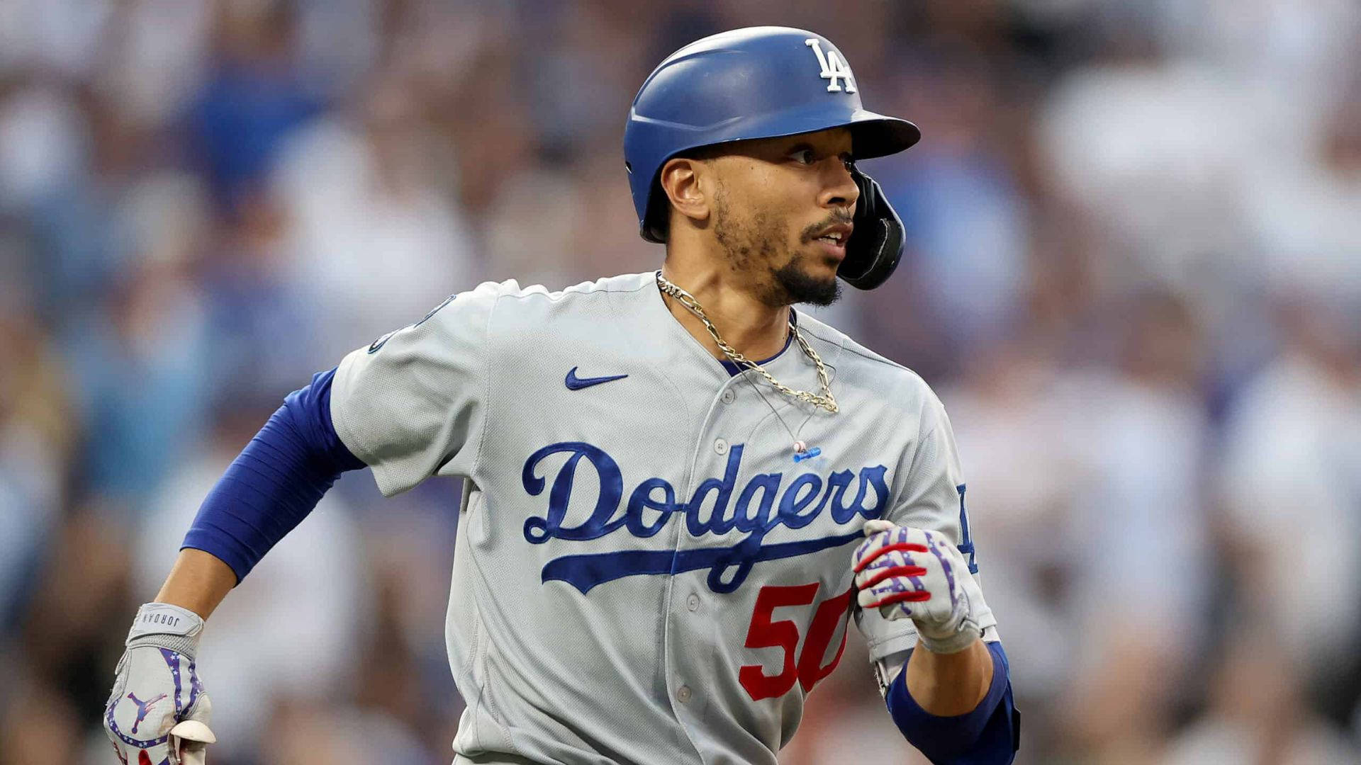 Mookie Betts 桌布 壁紙 — 一位身穿灰色球衣的洛杉磯道奇棒球運動員在夜間比賽中，在球場燈光下堅定地奔跑。