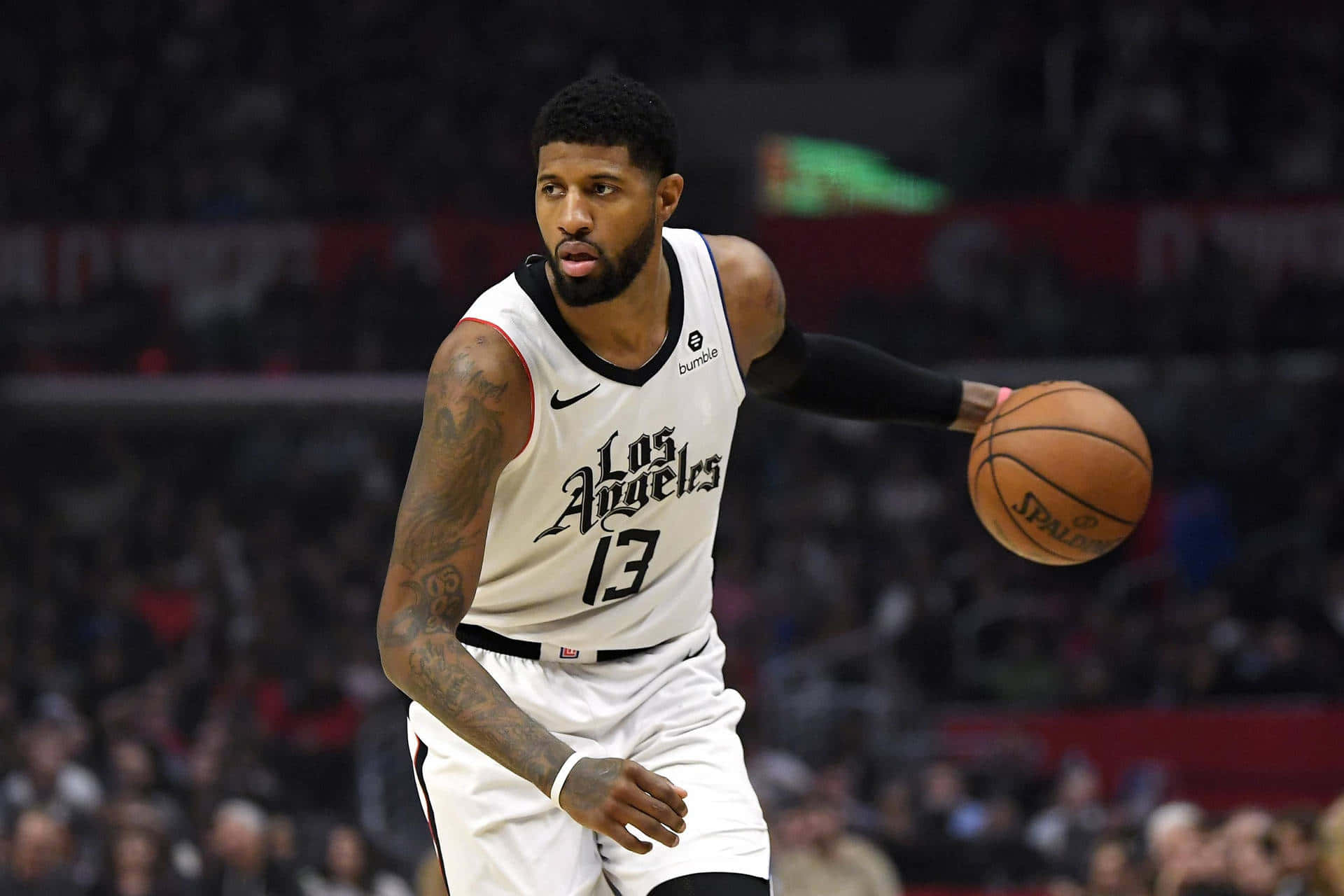 NBA 桌布 壁紙 — 一位身穿白色洛杉磯球衣的籃球運動員在場館燈光下進行激烈比賽時運球。