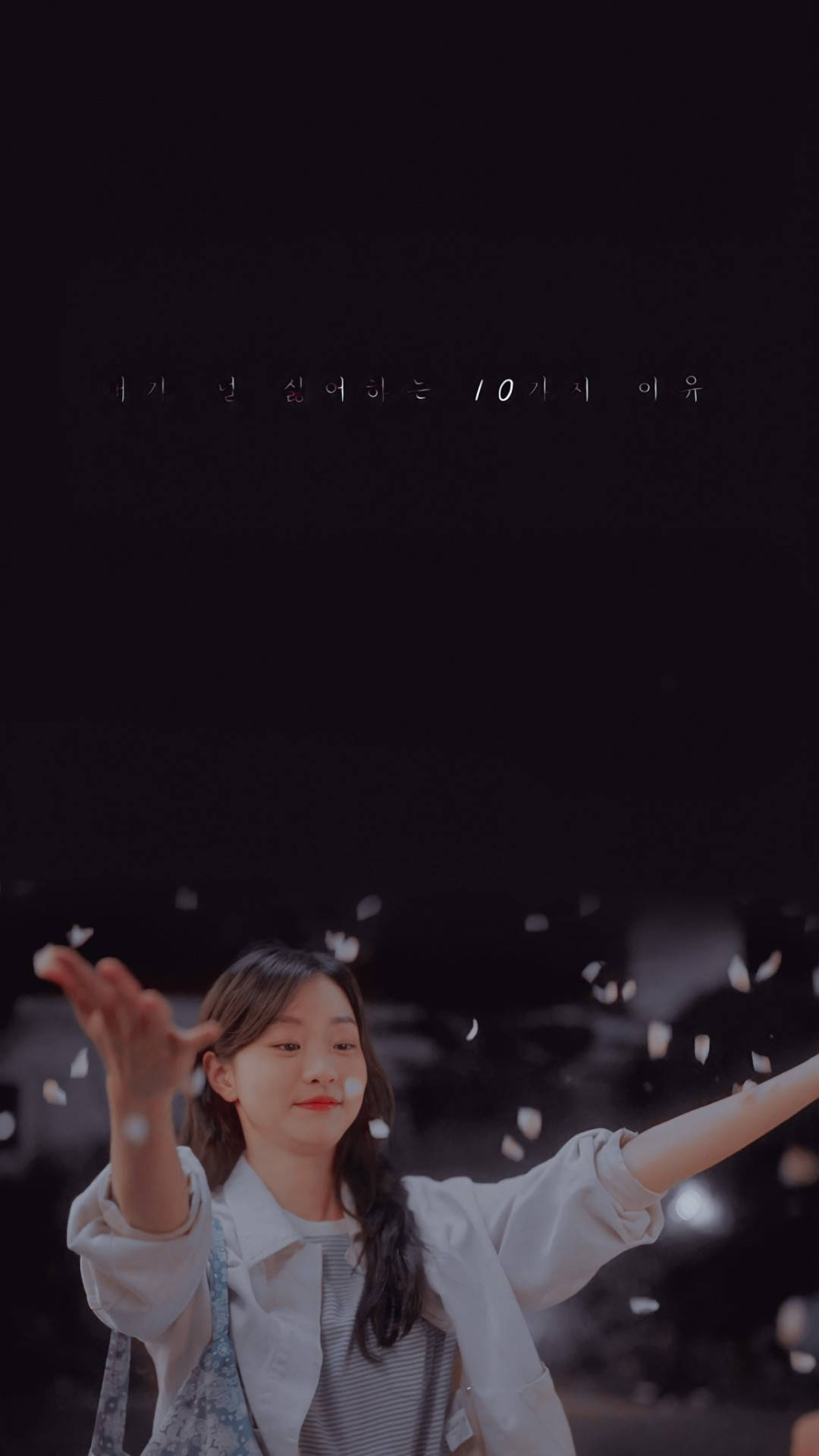 Beloved 桌布 壁紙 — 一位身穿白襯衫的年輕女性，在漆黑的夜空背景下，伴隨著柔和發光的燈光，歡快地將花瓣拋向空中。