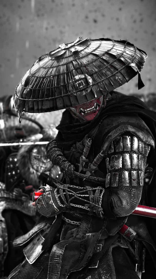 Ghost Of Tsushima iPhone 桌布 壁紙 — 一位身穿精細盔甲、頭戴寬邊帽的武士戰士，手持武士刀蓄勢待發，他的紅色面罩與單色戰場背景形成對比。