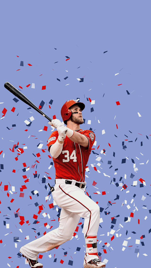 harper 桌布 壁紙 — 一位身穿紅色34號球衣的棒球選手揮動球棒，紅、白、藍三色紙屑在他周圍爆炸，背景為純藍色。