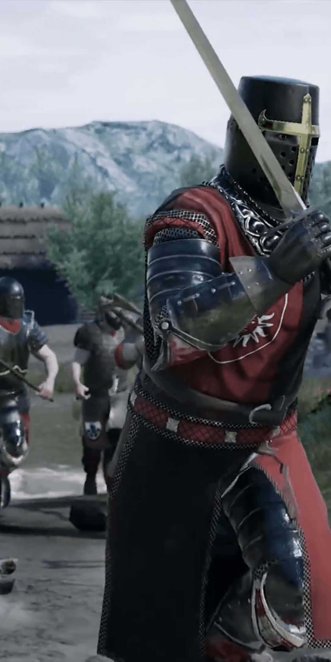 Pixel 3 Mordhau 桌布 壁紙 — 一位身穿紅黑盔甲的騎士在中世紀村莊揮舞劍，背景有山脈。