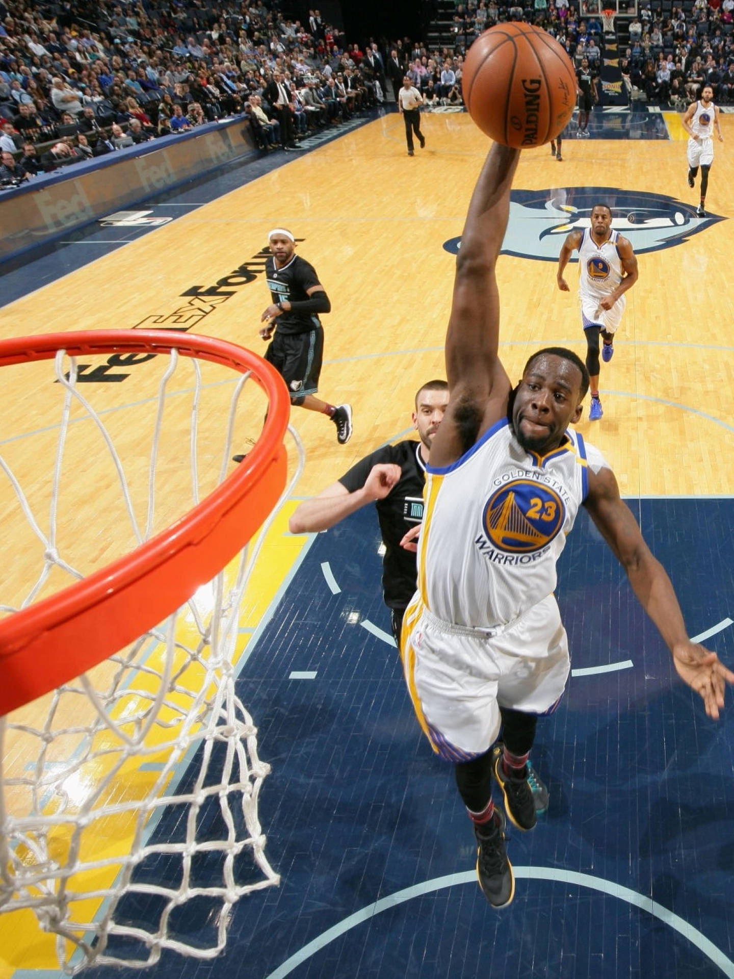 Draymond Green 桌布 壁紙 — 一位身穿金州勇士隊球衣的籃球運動員在比賽中專注地灌籃。