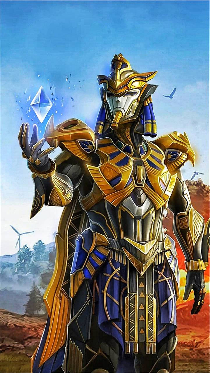pubg pharaoh 桌布 壁紙 — 一位身穿金色和藍色盔甲、戴著埃及頭飾的戰士，在風力渦輪機和鳥兒的天空中手持一顆發光的鑽石。