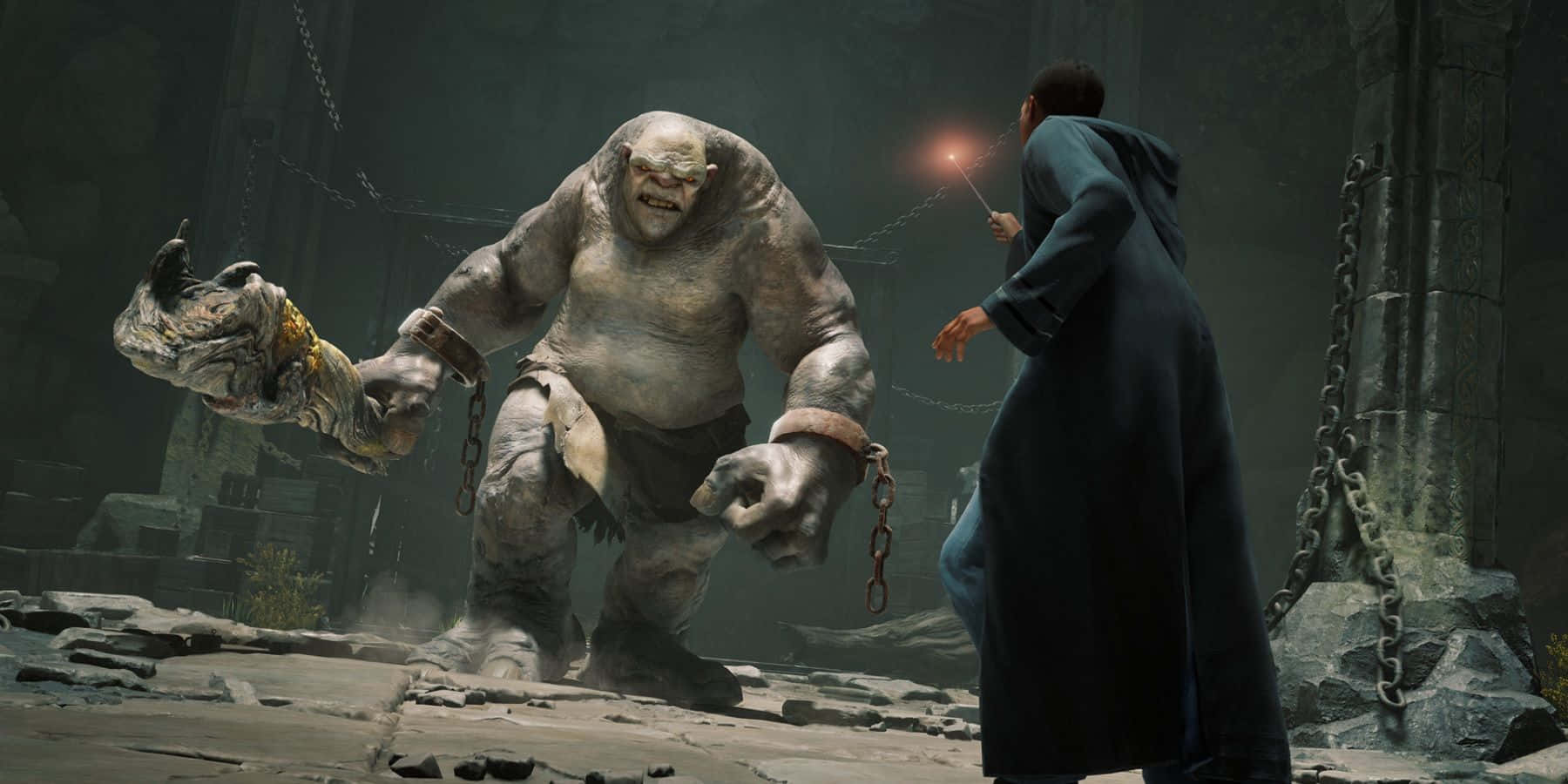 The Battle Of Hogwarts 桌布 壁紙 — 一位身穿黑色長袍的巫師在一個破敗的石頭地牢中，向一個被鎖鏈束縛的怪物施放發光的法術。