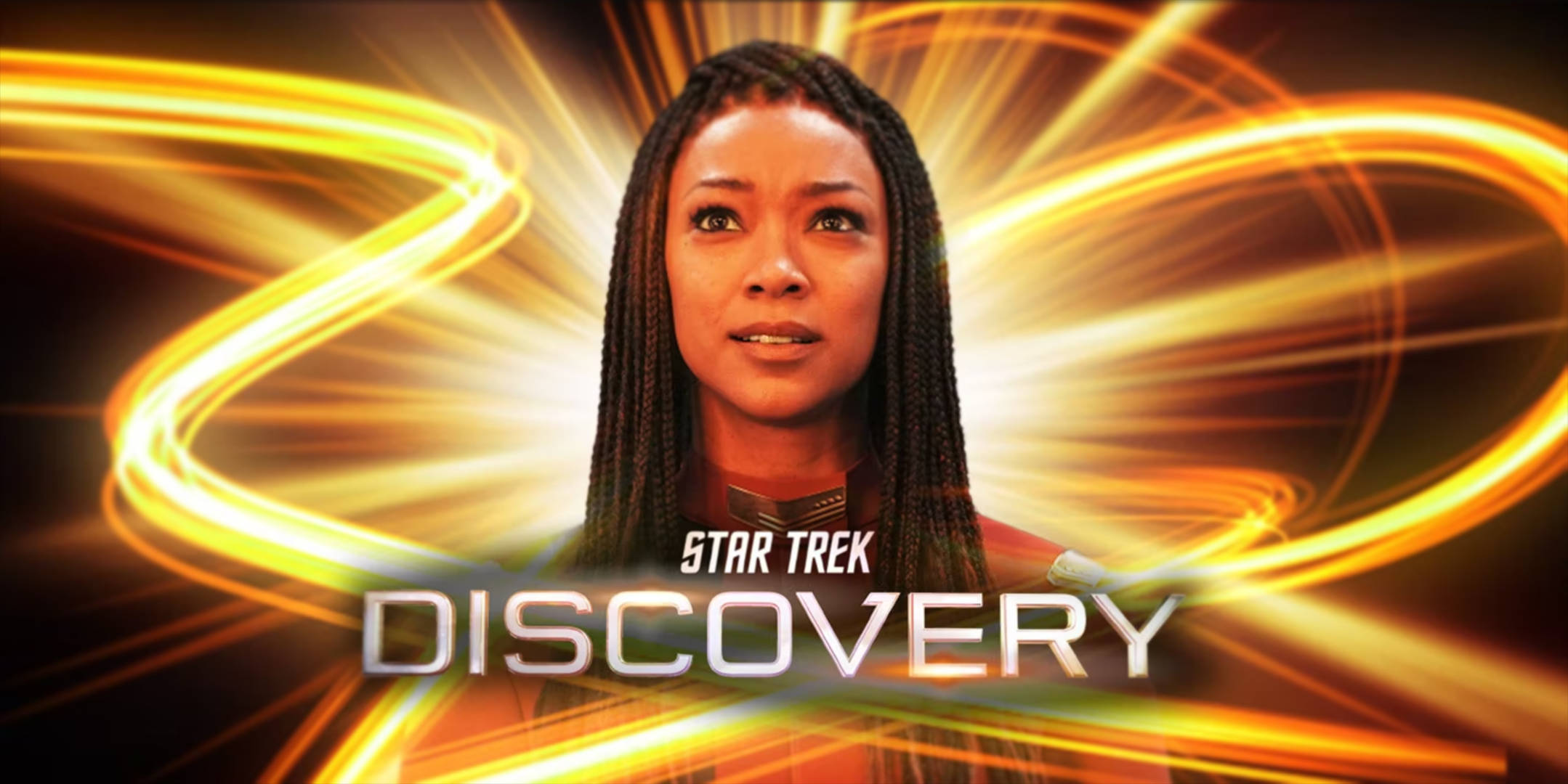 Discovery 桌布 壁紙 — 一位辮子女性站在發光的金色能量漩渦背景前，帶有'Star Trek Discovery'文字。
