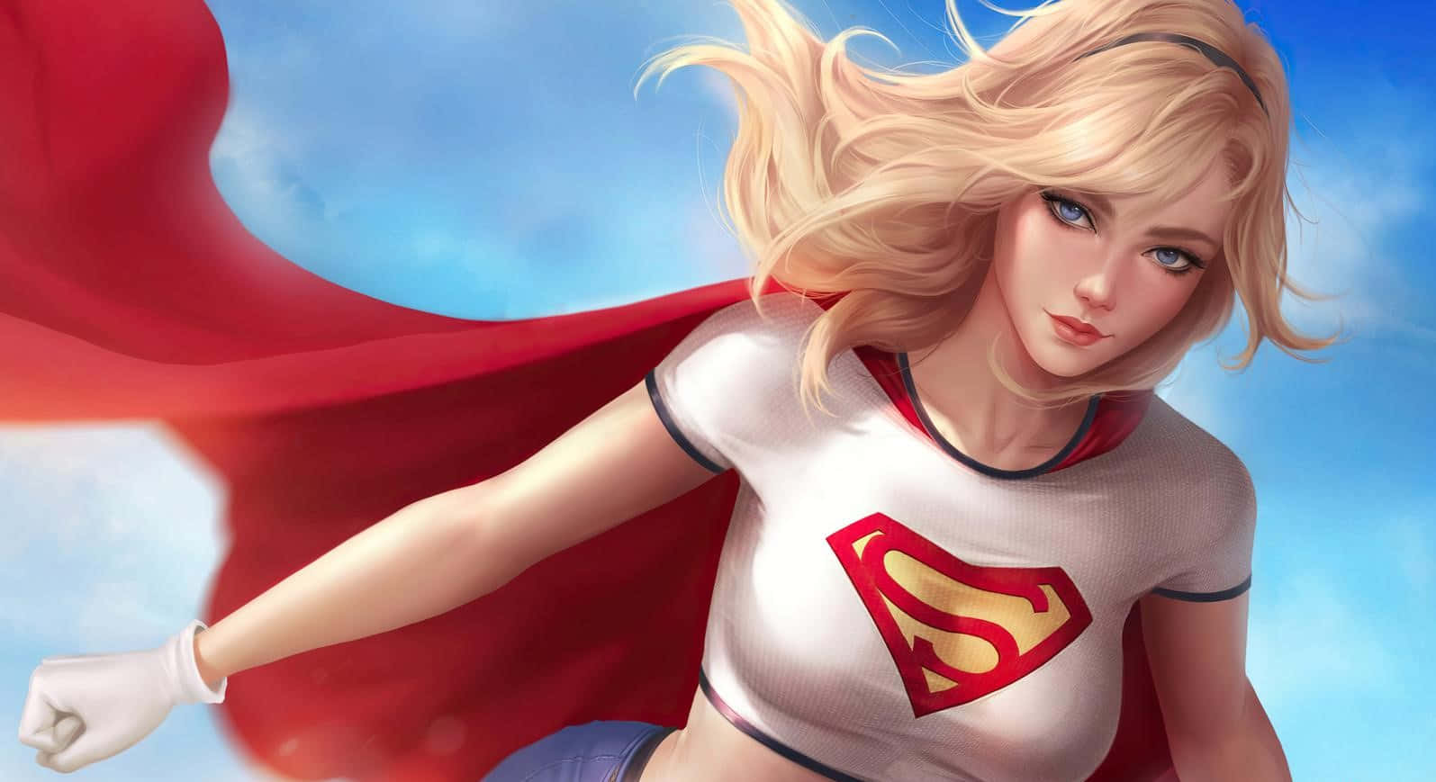 Comics 桌布 壁紙 — 一位金髮女超級英雄，身穿白色緊身衣、紅色斗篷和S盾牌，在明亮的藍天中飛翔，頭髮隨風飄揚。