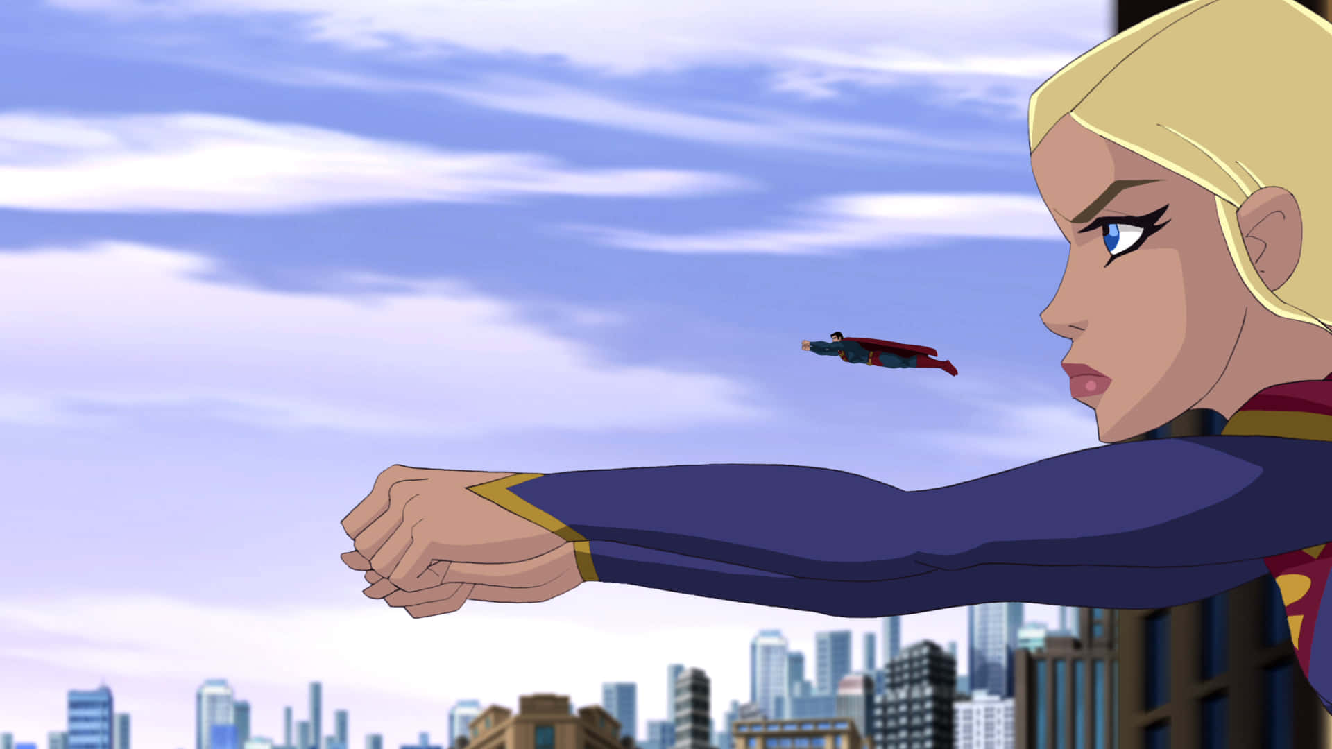 Superman Unbound 桌布 壁紙 — 一位金髮女超級英雄身穿藍色套裝，向著遠處飛翔的超人伸出手臂，背景是陰雲密佈的城市天際線。