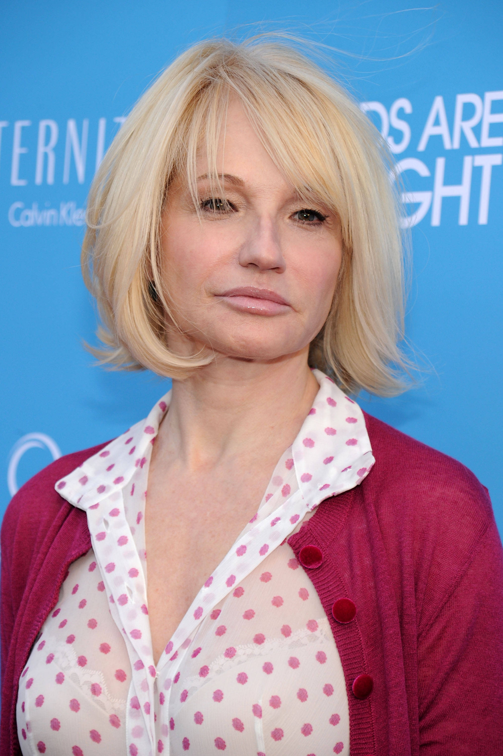 Celebrity 桌布 壁紙 — 一位金髮鮑伯頭的女性，在藍色活動背景前，穿著栗色開襟衫內搭粉紅色圓點襯衫。