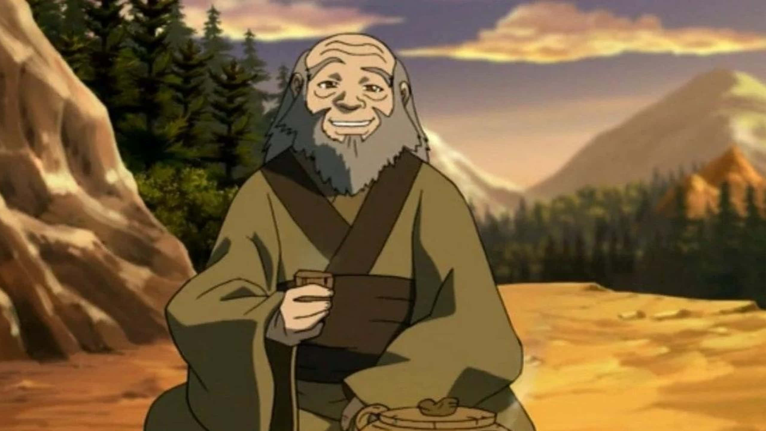 Uncle Iroh 桌布 壁紙 — 一位長著灰色長鬍鬚的年長動畫僧侶在日落時分的山林中微笑著拿著杯子。