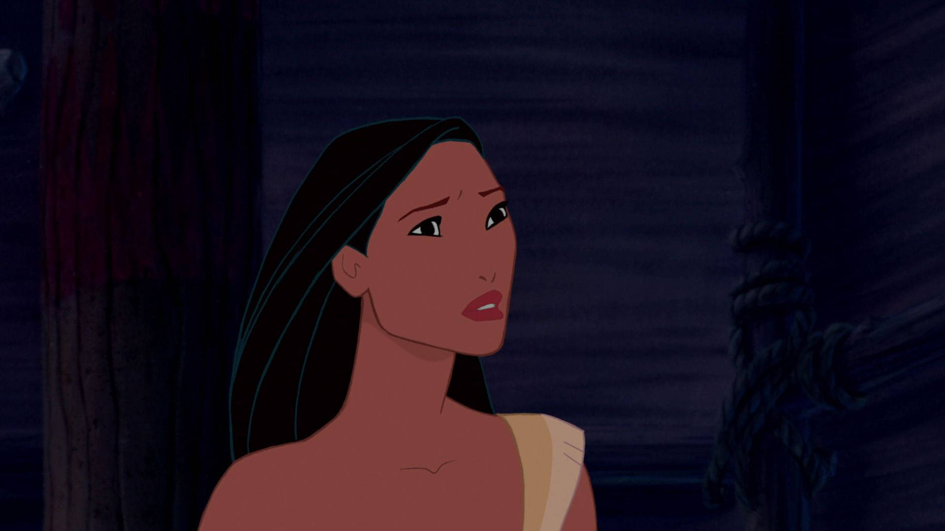 Pocahontas 桌布 壁紙 — 一位長髮深色年輕女性在昏暗的木質室內向上凝視，表情沉思而平靜。