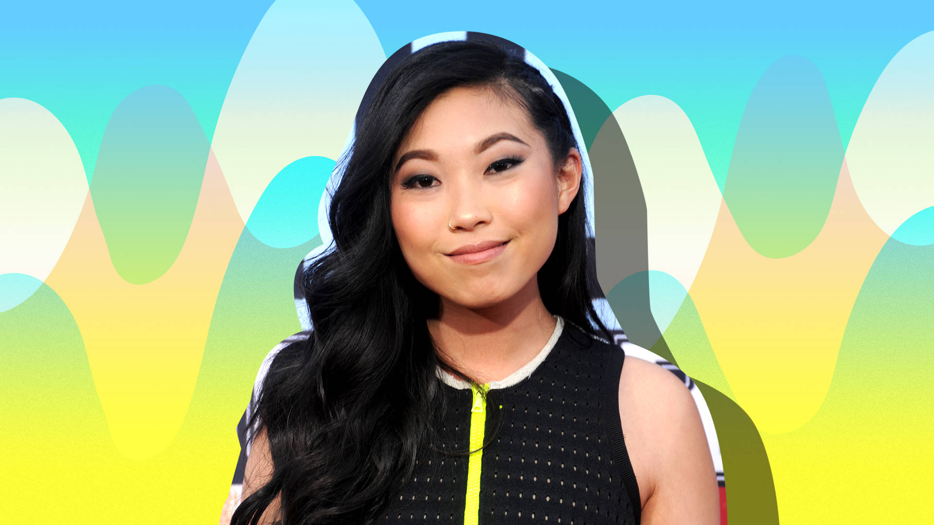 Awkwafina 桌布 壁紙 — 一位長黑髮的女性在流動的柔和波浪的鮮豔抽象背景前溫柔地微笑。