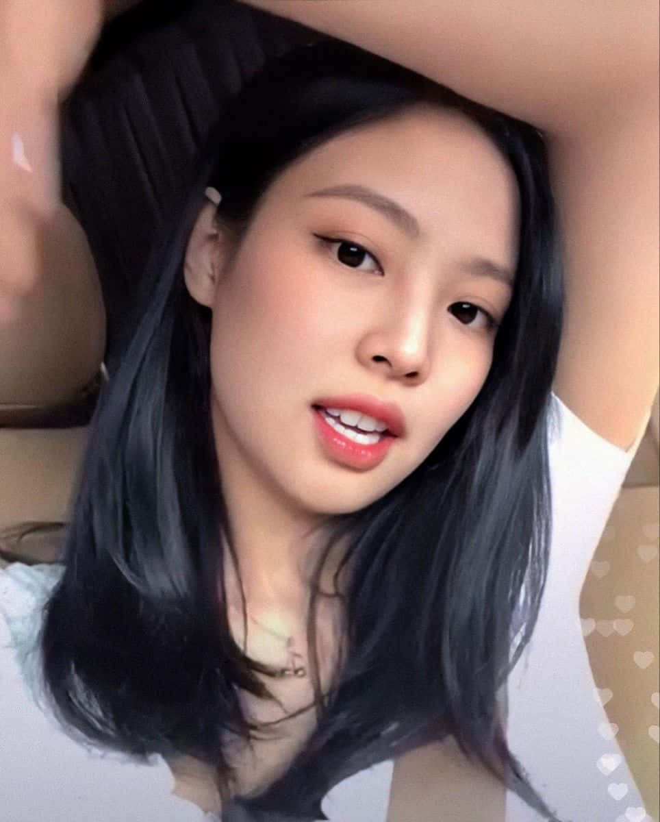 BLACKPINK 桌布 壁紙 — 一位長黑髮的年輕女性微笑著靠在汽車座椅上，雙臂舉起。