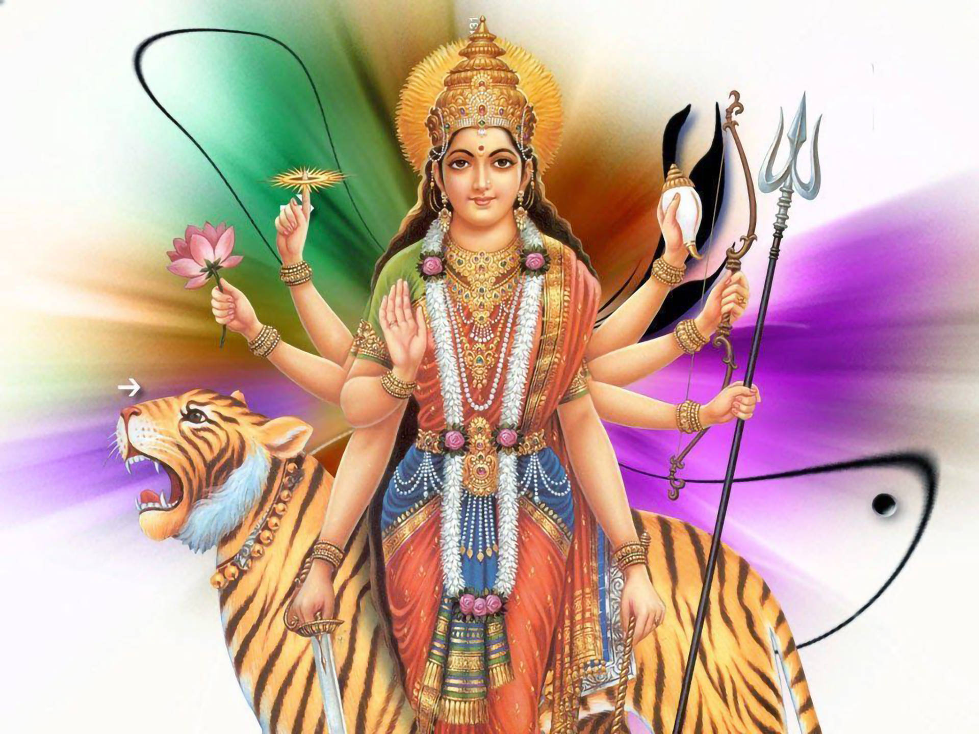 Mata Rani 桌布 壁紙 — 一位閃耀的多臂印度教女神，佩戴黃金珠寶和色彩繽紛的服飾，騎著咆哮的老虎，背景是充滿活力的彩虹光環。