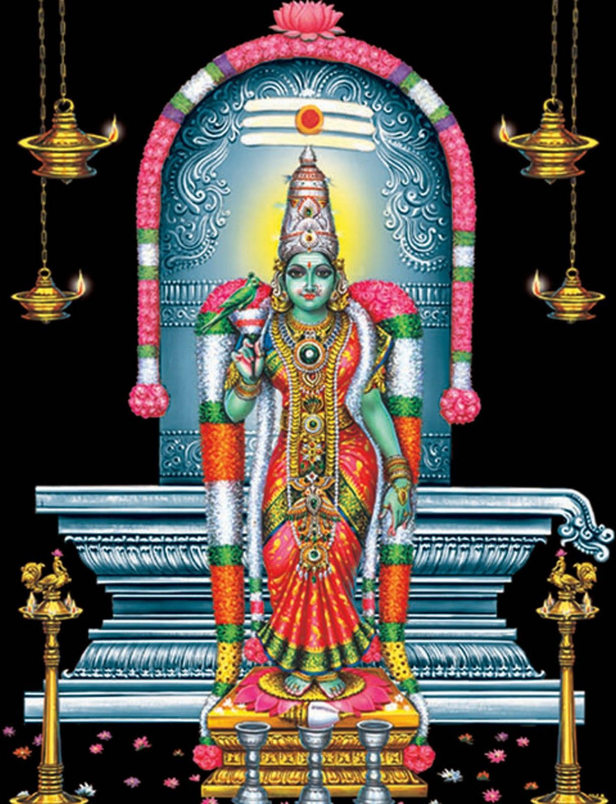 Mariamman 桌布 壁紙 — 一位閃耀的綠色皮膚印度教神祇，身穿紅金色服飾，坐在藍色寶座上，上方有花卉拱門和懸掛的油燈。