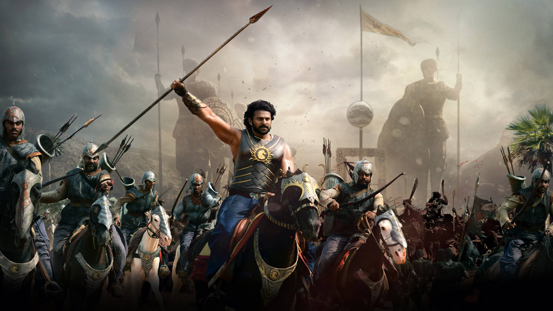 Prabhas HD 桌布 壁紙 — 一位騎馬的戰士帶領一支裝甲騎兵軍隊穿越風暴肆虐的戰場，背景是古代遺跡和一座高聳的雕像。