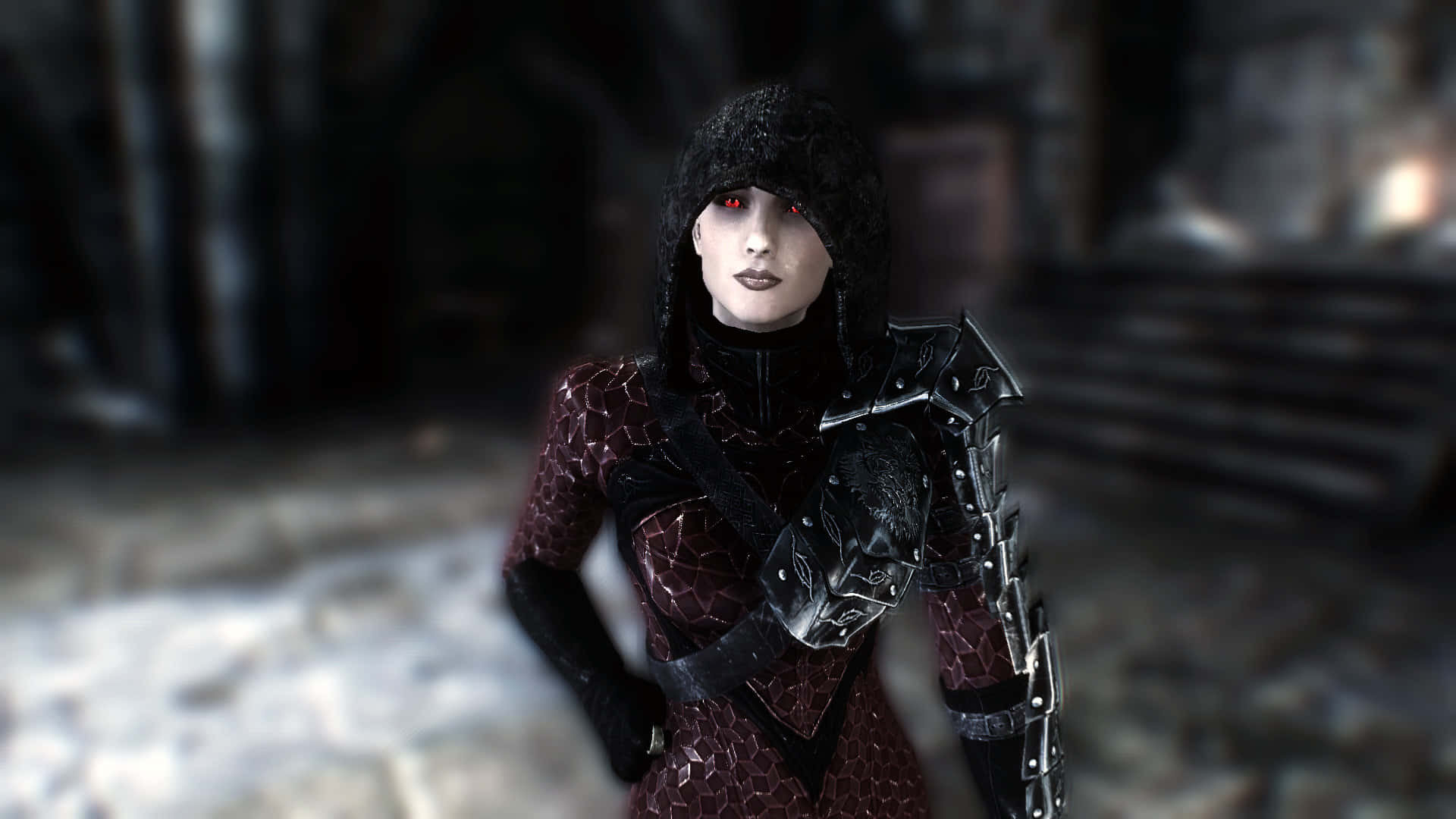 Skyrim Serana 桌布 壁紙 — 一位黑暗奇幻戰士，擁有發光的紅色眼睛和黑色盔甲，站在廢棄的石結構中。