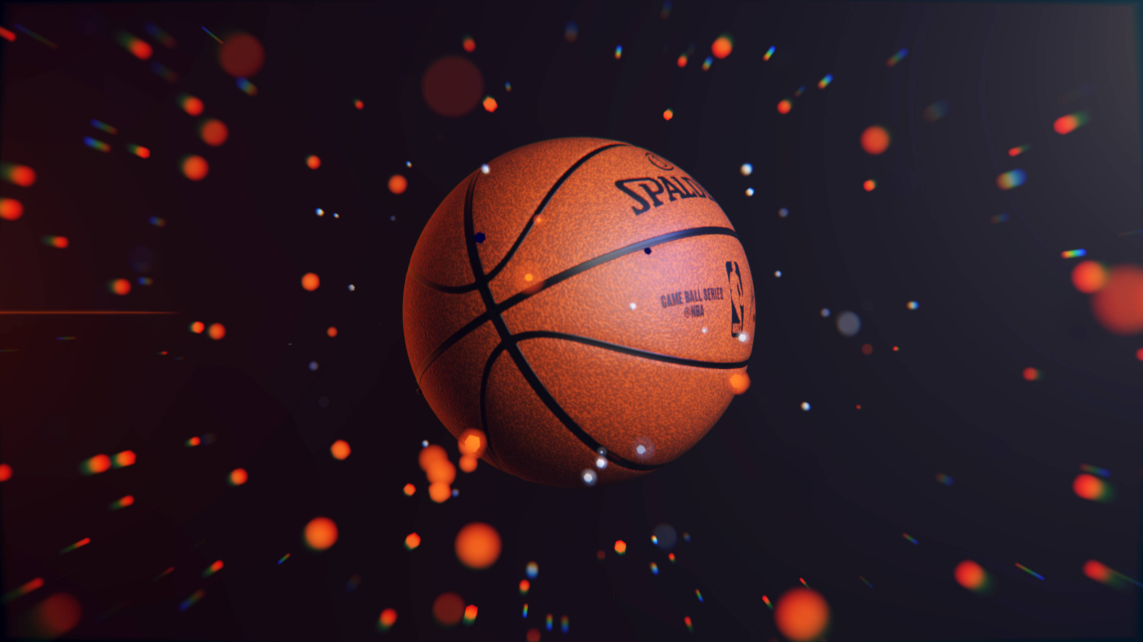4K籃球壁紙 桌布 壁紙 — 一個 Spalding NBA 籃球在黑暗的宇宙背景下漂浮在發光的橙色和藍色粒子之間。