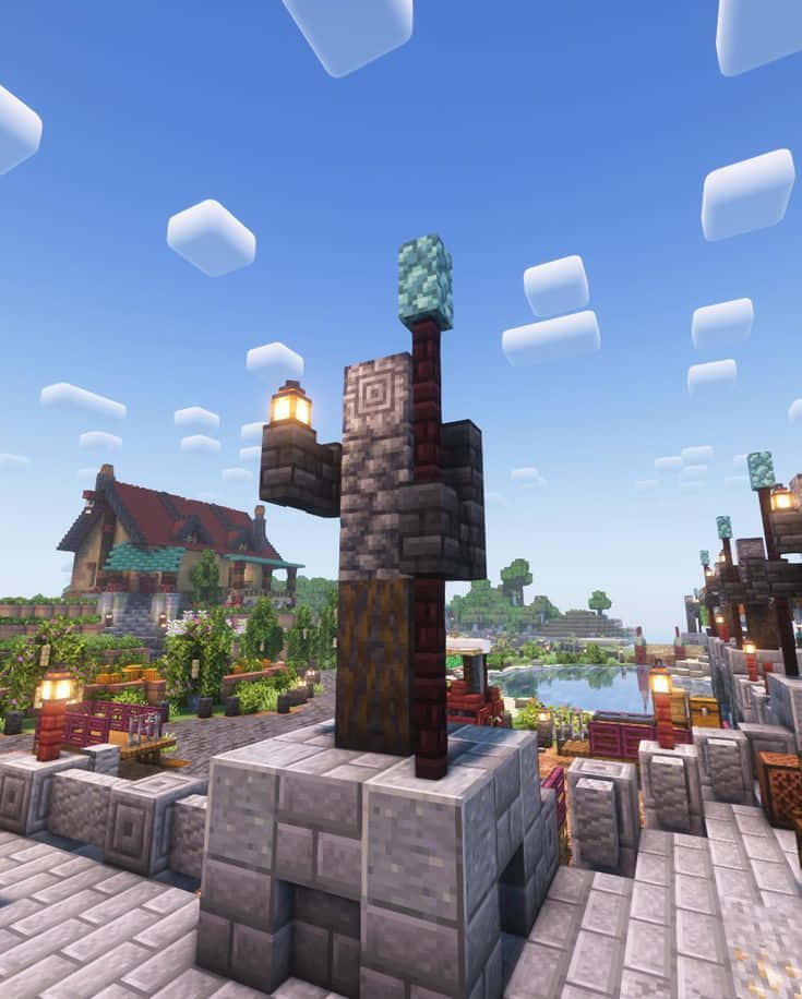 Minecraft Characters 桌布 壁紙 — 一個Minecraft村莊，有鵝卵石小路、發光的燈籠和鑽石方塊塔，背景是晴朗的藍天和方塊狀雲朵。