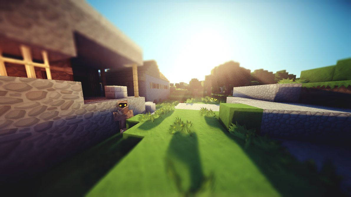 我的世界 桌布 壁紙 — 一個Minecraft角色站在陽光明媚的草地村莊中，有石屋和方塊樹木，背景是明亮的藍天。