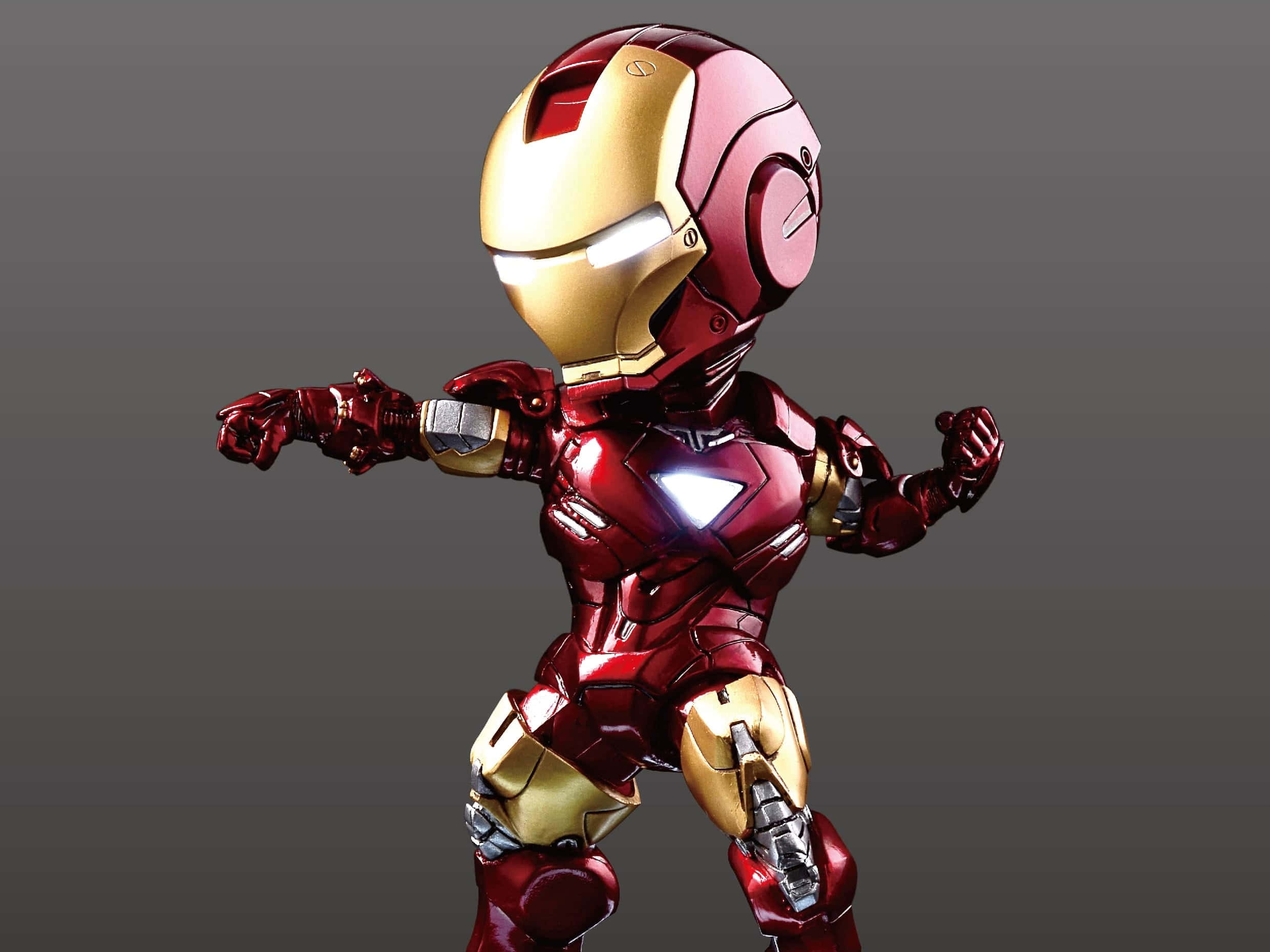 Iron Man Action Figures 桌布 壁紙 — 一個Q版風格的鋼鐵人公仔，身穿紅色和金色裝甲，在純灰色背景上動態地站立。