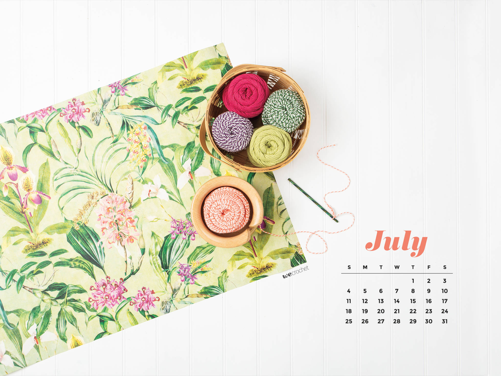 2021 Calendar 桌布 壁紙 — 一個七月日曆放在一個白色木質表面上，旁邊有一籃彩色紗線和花卉圖案布料。