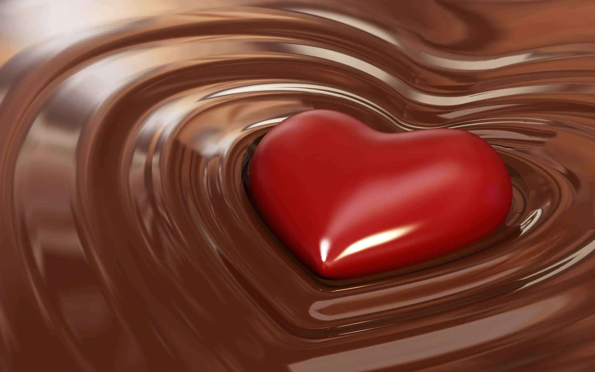 Chocolate 桌布 壁紙 — 一個亮面紅色心形放在旋轉的融化巧克力中，營造出豐富浪漫的視覺效果。