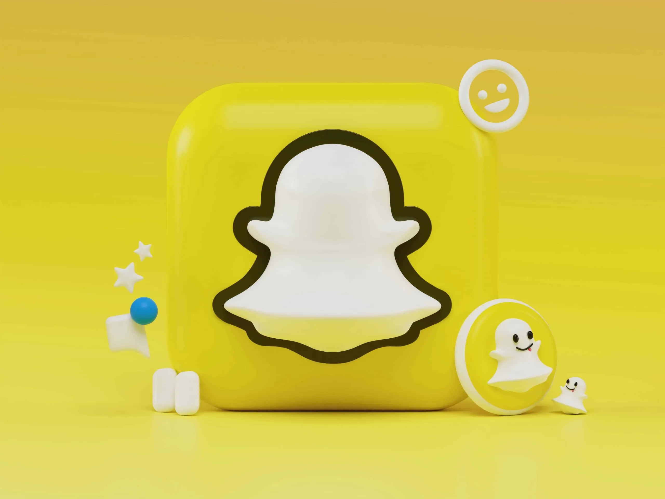 Group Chat 桌布 壁紙 — 一個亮黃色3D渲染的Snapchat標誌立方體，帶有鬼魂角色和圖標在匹配的黃色背景上漂浮。