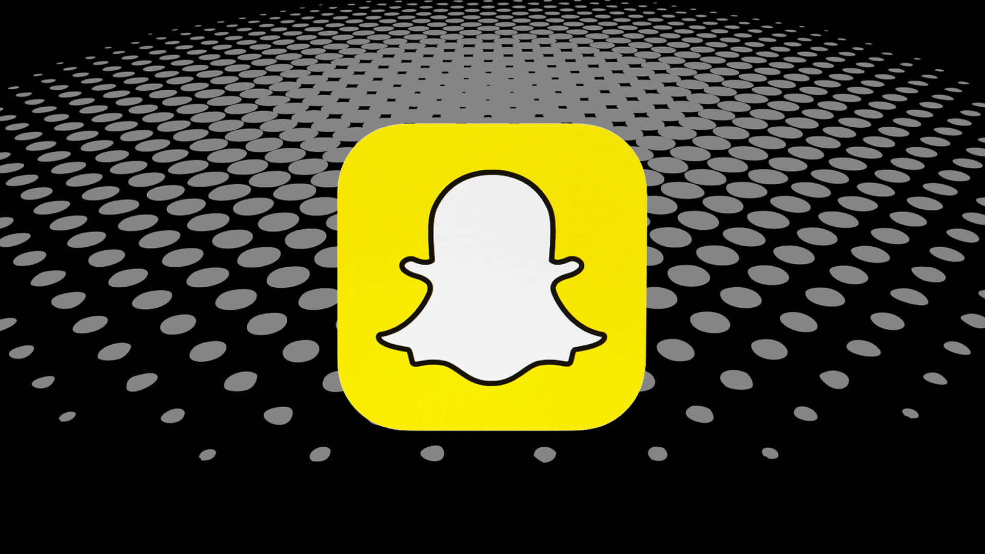 Snapchat 桌布 壁紙 — 一個亮黃色的Snapchat鬼魂圖示，居中在黑色背景上，帶有漸退的灰色圓點圖案。