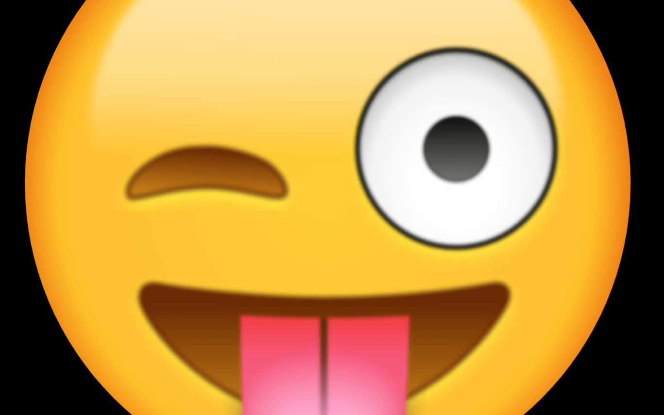 表情符號 桌布 壁紙 — 一個亮黃色的表情符號在黑色背景上單眼眨眼並頑皮地伸出舌頭。